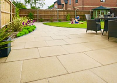 Large garden with sandstone paving